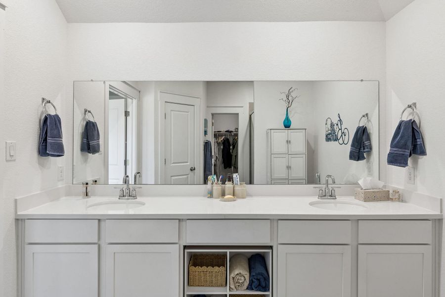 Double vanity featuring storage space and comfort height counters.