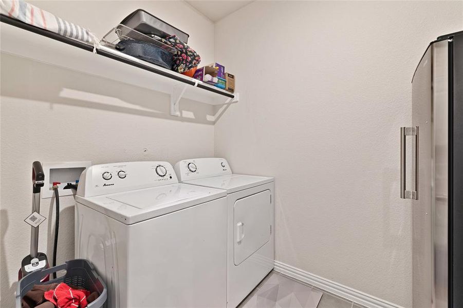 Laundry area with baseboards, laundry area, and washing machine and clothes dryer