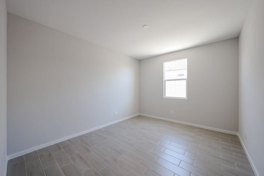 A room with a tile floor and windows.