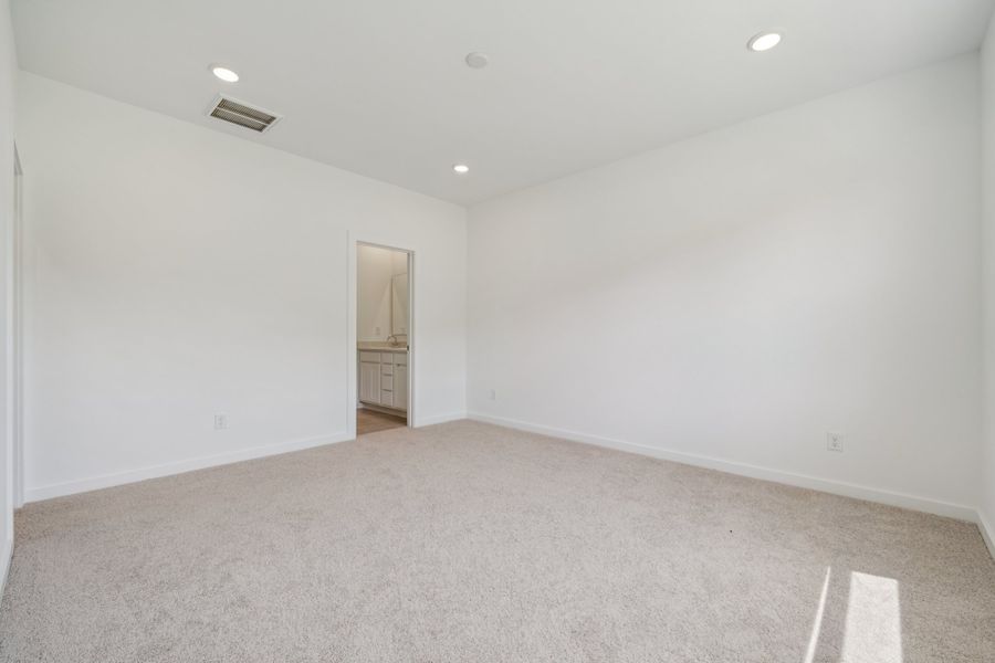 A room with a carpet and a door.