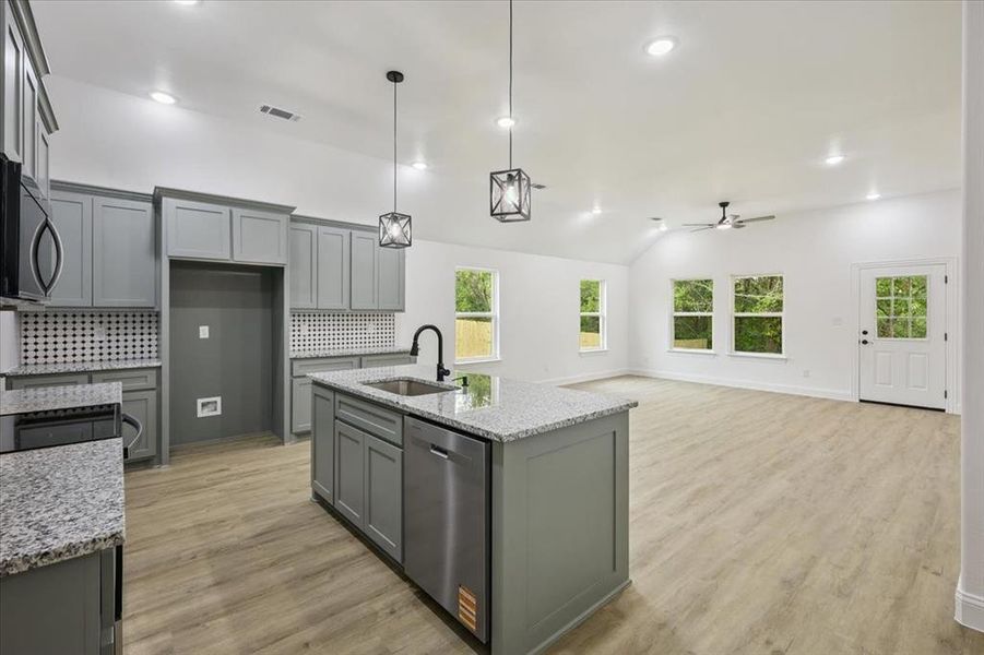 Kitchen featuring gray cabinets, backsplash, light wood-style flooring, dishwasher, and recessed lighting Kitchen featuring gray cabinets, backsplash, light wood-style flooring, dishwasher, and recessed lighting
