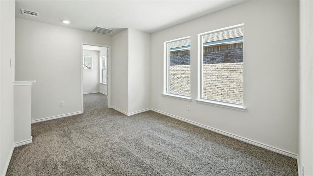 Carpeted empty room featuring baseboards