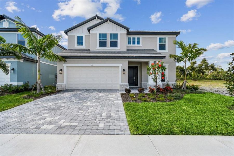 Front exterior of a new home in Hawkstone, Sarasota, FL, highlighting curb appeal (Image 1). Front exterior of a new home in Hawkstone, Sarasota, FL, highlighting curb appeal (Image 1).