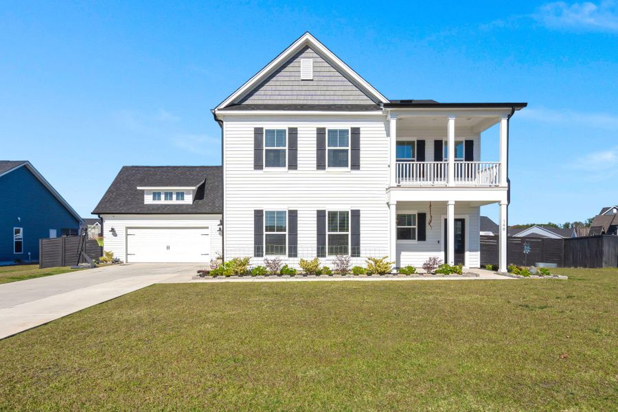 Front exterior of a new home in Timothy Lakes, Ridgeville, SC, highlighting curb appeal (Image 21). Front exterior of a new home in Timothy Lakes, Ridgeville, SC, highlighting curb appeal (Image 21).