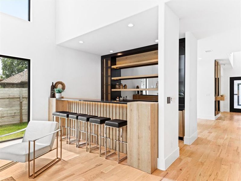 Bar with light wood-type flooring