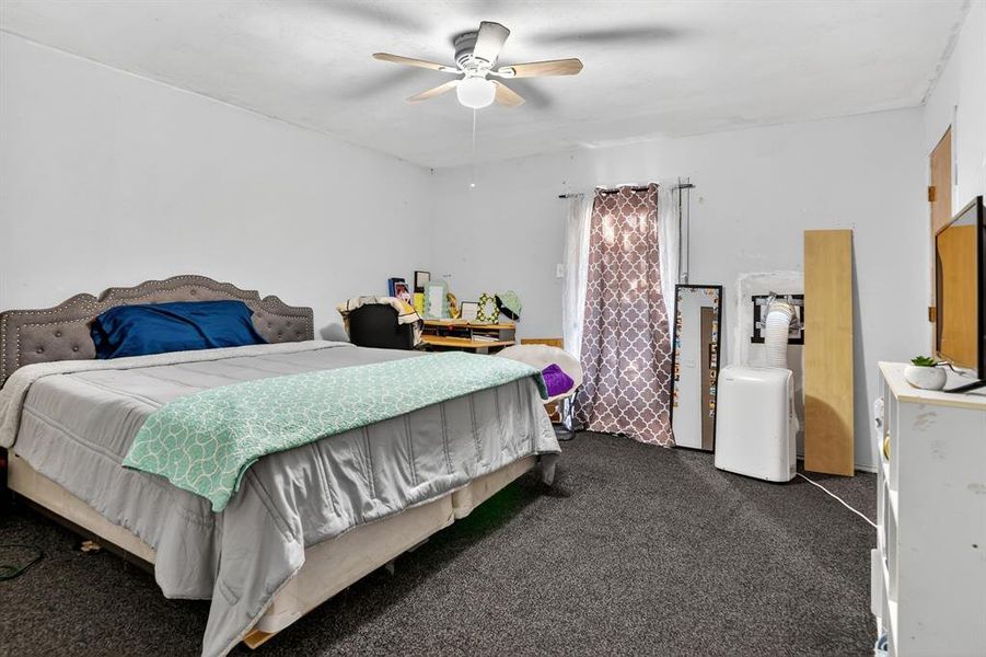 Bedroom with carpet flooring and ceiling fan Bedroom with carpet flooring and ceiling fan