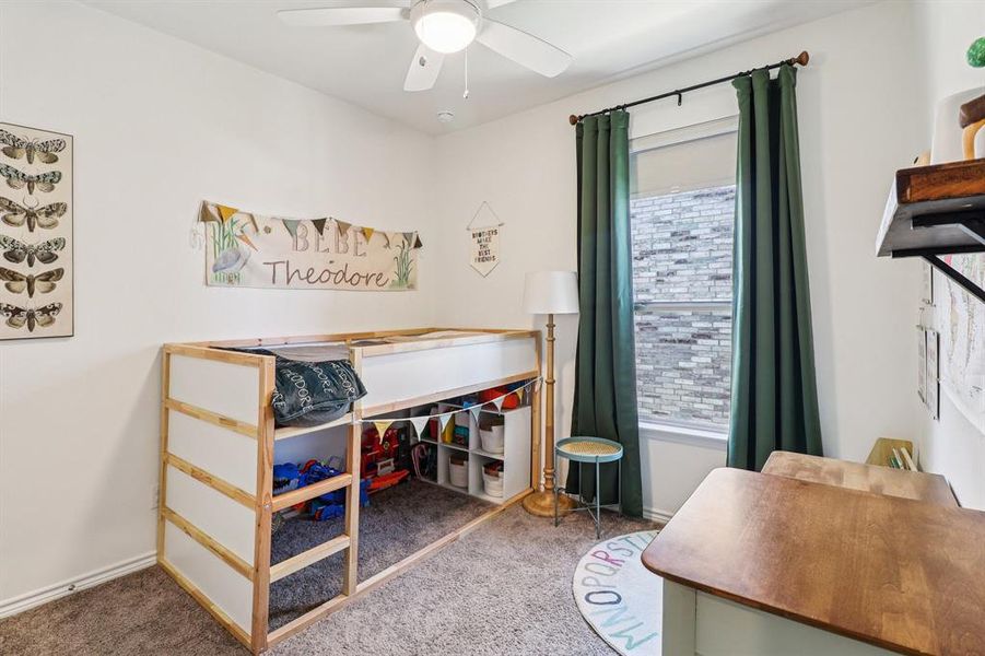 Carpeted bedroom with ceiling fan and baseboards Carpeted bedroom with ceiling fan and baseboards