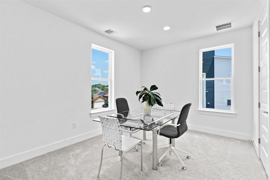 The spacious bedroom can also be utilized as an office or workout space.