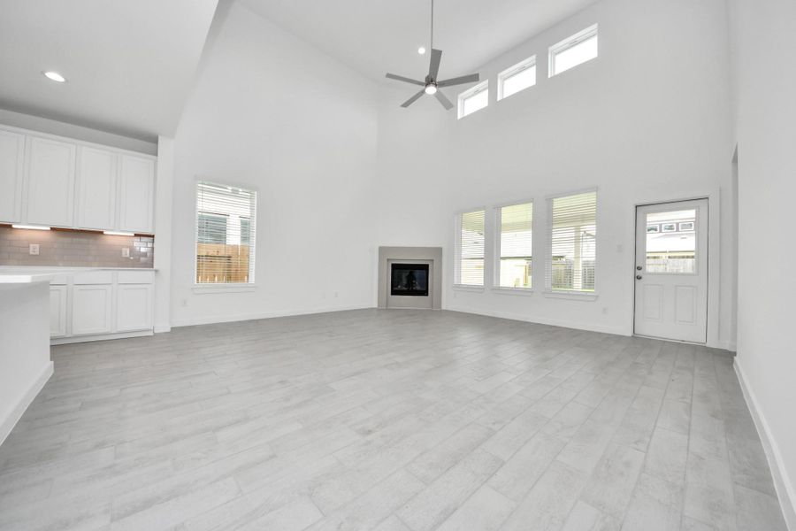 Take another glimpse into the heart of the home with this additional view of the family room—a sprawling space ready to accommodate all your gatherings. Sample photo of completed home with similar floor plan. Actual colors and selections may vary.