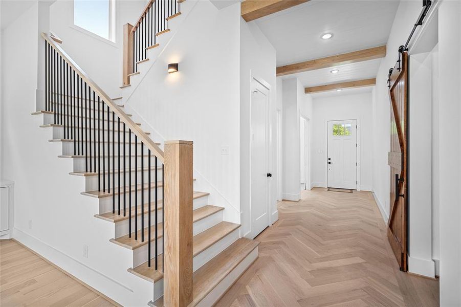 Here you get a closer look at the flooring and ceiling details. The 4th bedroom (perfect for an office) is located at the front of the house with an en-suite full bath that can be accessed from the hallway. To the right is the mud room.