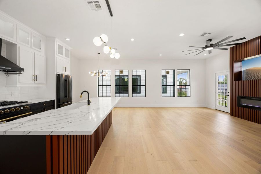 Step into the open kitchen an living area, where the spaces flow seamlessly together to create a welcoming setting for everyday living, dining, and entertaining.