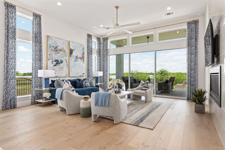 Living area with light wood-type flooring, recessed lighting, and ceiling fan Living area with light wood-type flooring, recessed lighting, and ceiling fan