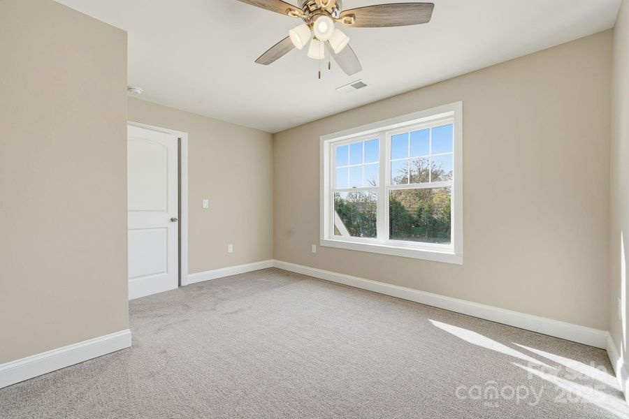 Bright secondary bedroom with large window and plush carpeting. Bright secondary bedroom with large window and plush carpeting.