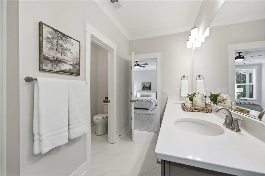 A sleek double vanity with stone countertops highl