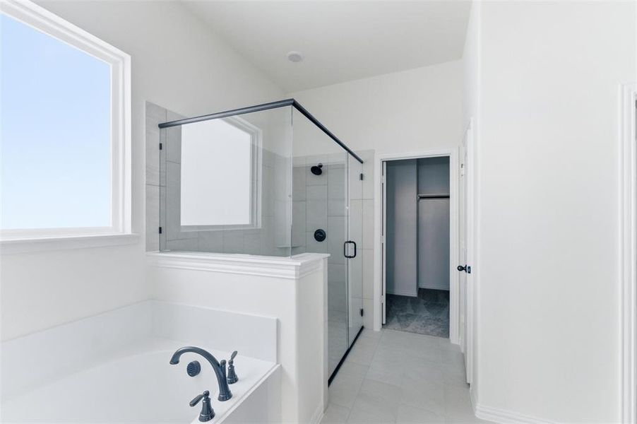 Bathroom featuring a shower stall and a garden tub