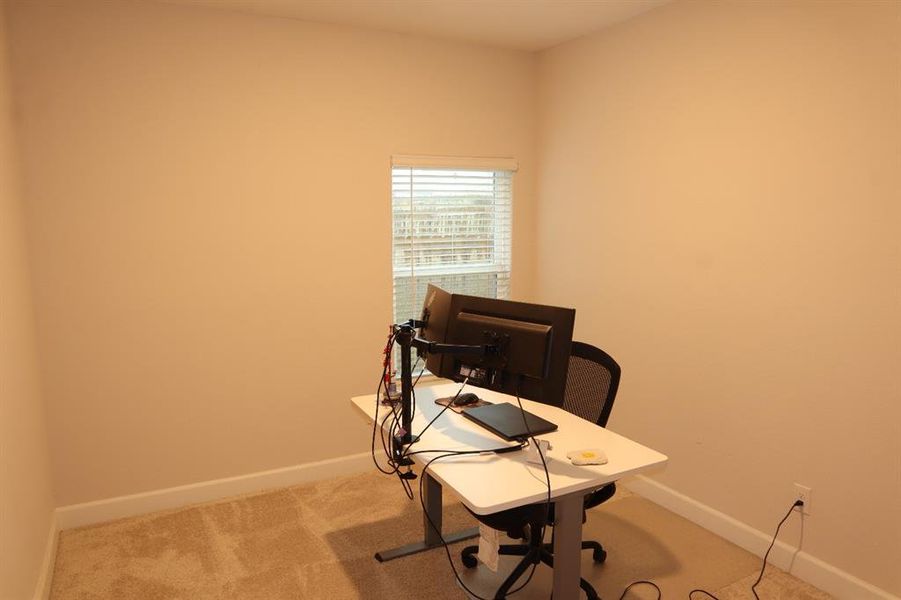 Carpeted office with baseboards