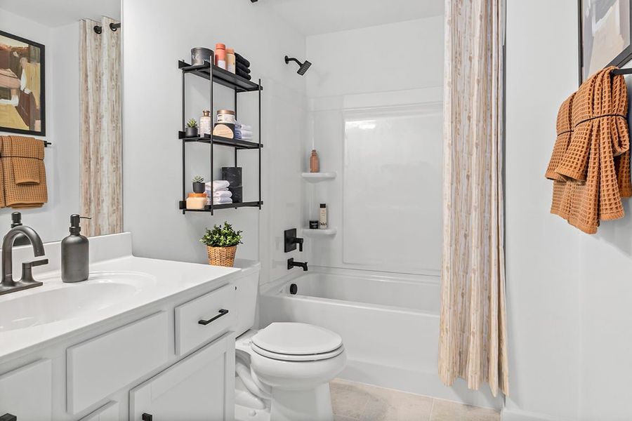 A bathroom with a tub sink and toilet.