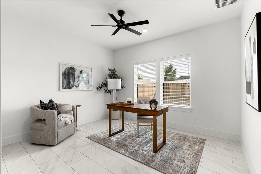 First floor bedroom featuring white walls, large windows, and a ceiling fan. First floor bedroom featuring white walls, large windows, and a ceiling fan.