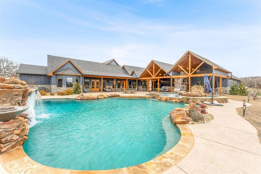 View of pool featuring a patio area and a pool with connected hot tub