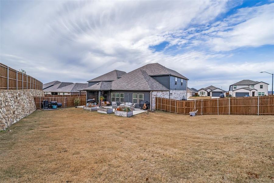 Back of property with a fenced backyard, a patio, outdoor lounge area, and roof with shingles Back of property with a fenced backyard, a patio, outdoor lounge area, and roof with shingles