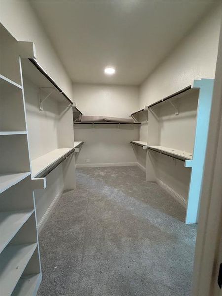 Primary closet conveniently connects to the utility room