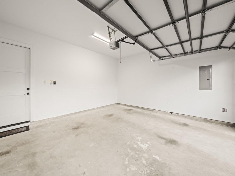 2-Car Garage featuring breaker box, and 10 ft. ceiling