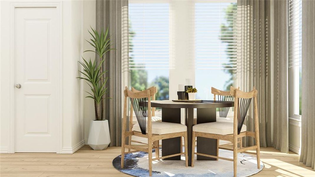 Dining room with light hardwood / wood-style flooring and a healthy amount of sunlight