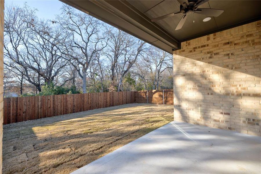 View of yard with ceiling fan and a patio area