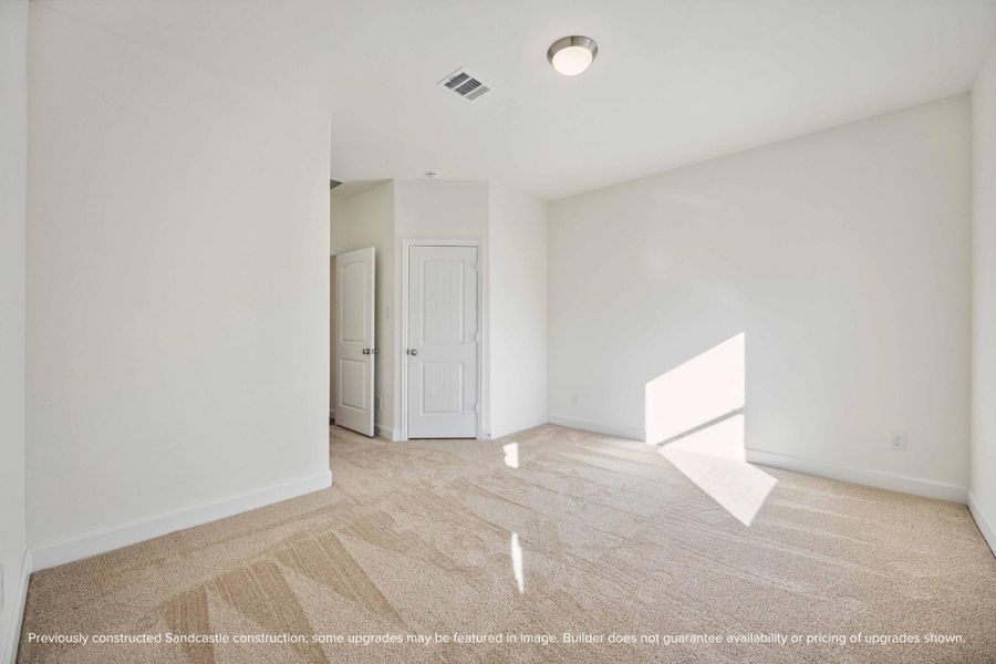 Let the sunlight pour in. This secondary bedroom feels anything but secondary with its spacious layout and warm energy.
