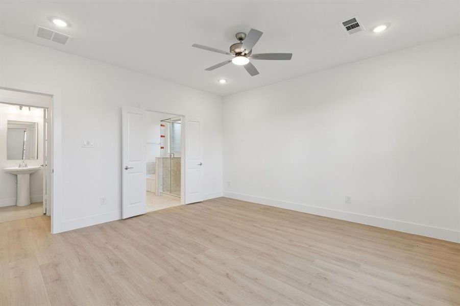 Unfurnished bedroom featuring connected bathroom, light wood-style floors, recessed lighting, and ceiling fan Unfurnished bedroom featuring connected bathroom, light wood-style floors, recessed lighting, and ceiling fan