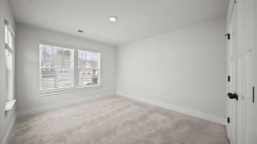First-class bedroom with generous proportions, a walk-in closet, and beautiful natural light through large windows