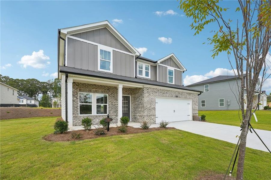 Front exterior of a new home in Northwoods at Mirror Lake, Villa Rica, GA, highlighting curb appeal (Image 23).