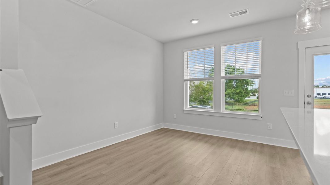 Established charm meets modern elegance in this open concept breakfast area by DRB Homes