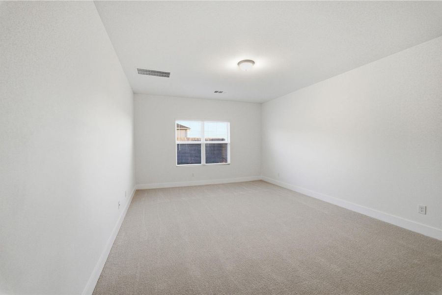 Spare room with light carpet and baseboards