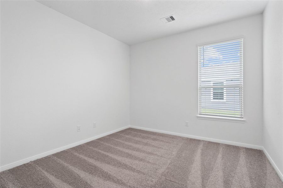 The Den features custom neutral paint, recessed lighting, large window with blinds, and plush carpet flooring. An additional living space to be used as an office, seating area, hobby or play room.