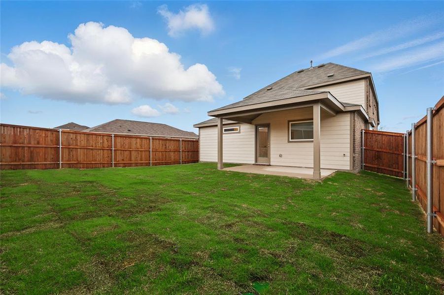 Back of property with a patio and a fenced backyard