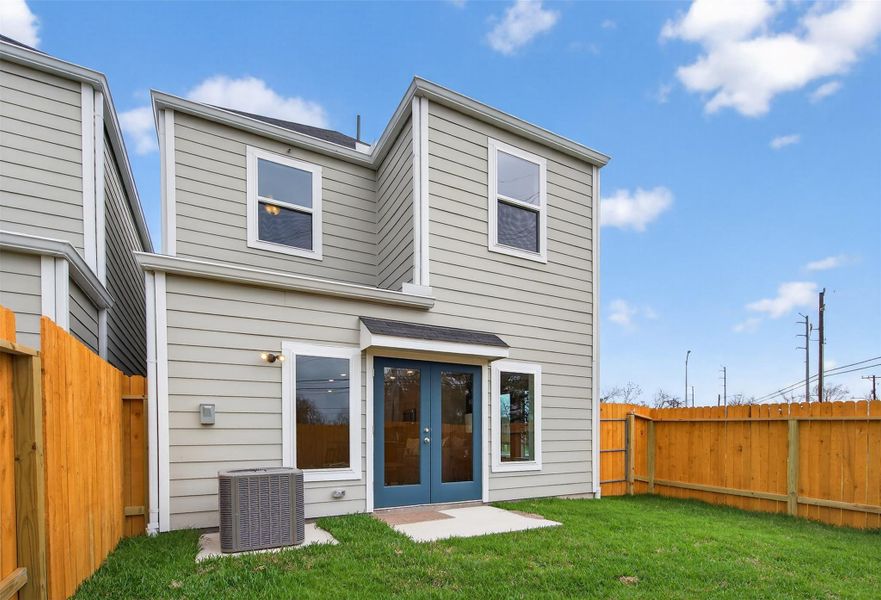 Charming rear elevation with clean siding lines, multiple windows for natural light, and a spacious yard perfect for relaxation or entertaining. Charming rear elevation with clean siding lines, multiple windows for natural light, and a spacious yard perfect for relaxation or entertaining.