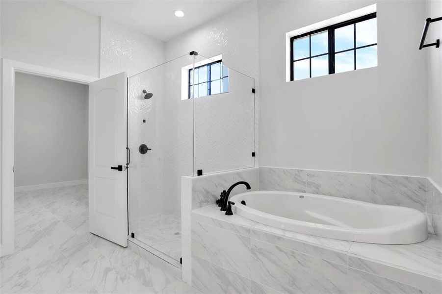 Bathroom with independent shower and bath and tile patterned floors