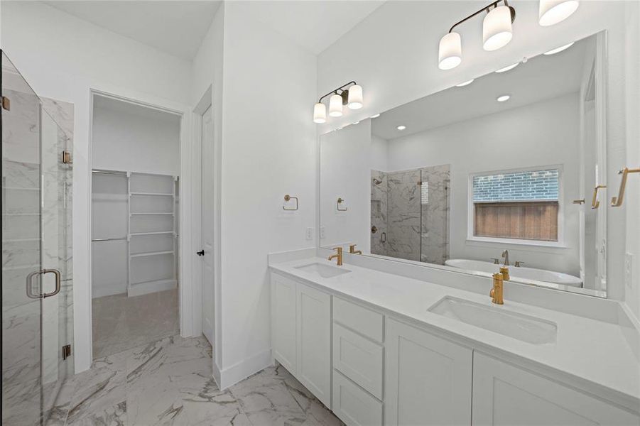 Bathroom with a marble finish shower, light marble finish flooring, a freestanding bath, and a spacious closet Bathroom with a marble finish shower, light marble finish flooring, a freestanding bath, and a spacious closet