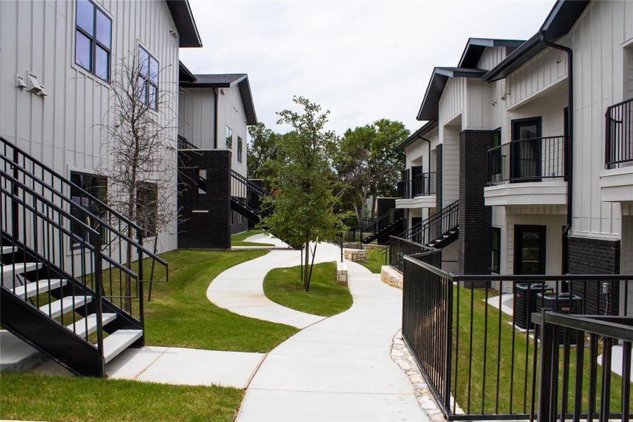 Surrounding community with a lawn, stairway, and a residential view