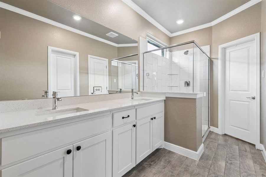 Dual vanity with white shaker cabinetry, speckled countertops, and undermount sinks