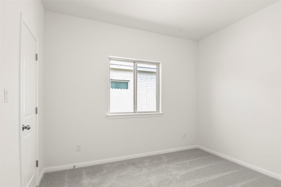 Empty room with carpet and baseboards