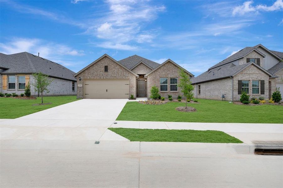 Front exterior of a new home in Woodstone, Providence Village, TX, highlighting curb appeal (Image 22).