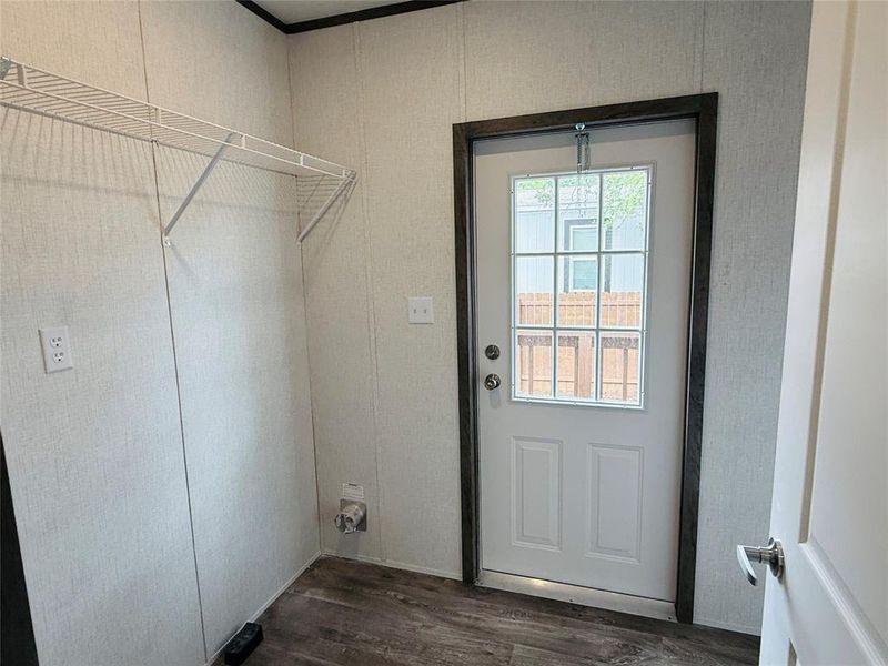 Laundry room featuring dark wood finished floors