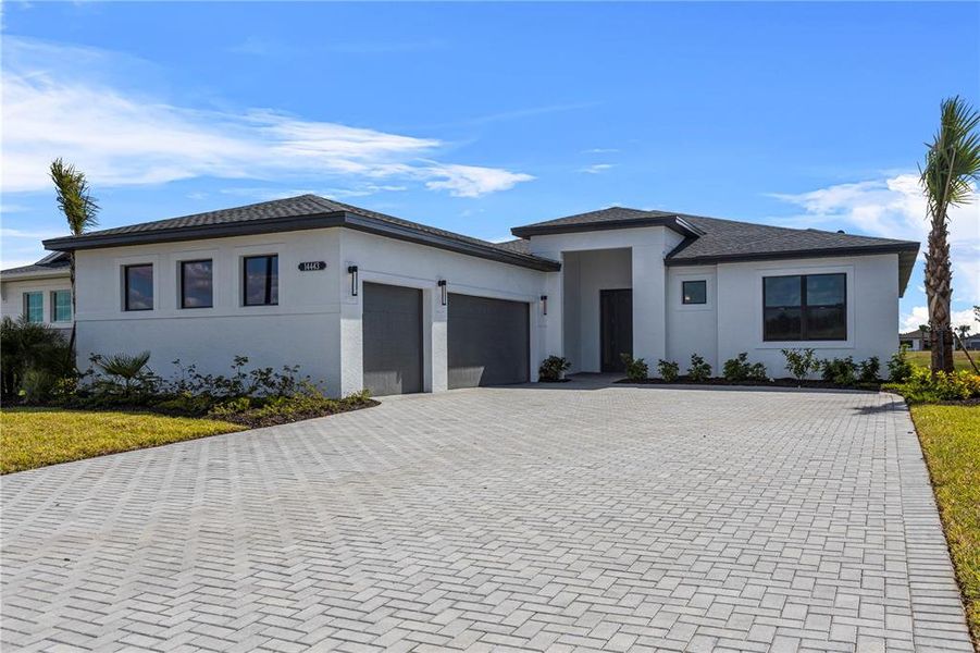 Front exterior of a new home in Woodland Preserve, Parrish, FL, highlighting curb appeal (Image 2). Front exterior of a new home in Woodland Preserve, Parrish, FL, highlighting curb appeal (Image 2).