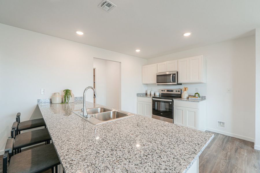 A kitchen with marble counters.