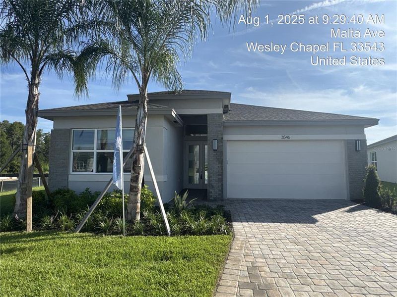 Front exterior of a new home in Valencia Ridge, Wesley Chapel, FL, highlighting curb appeal (Image 17).