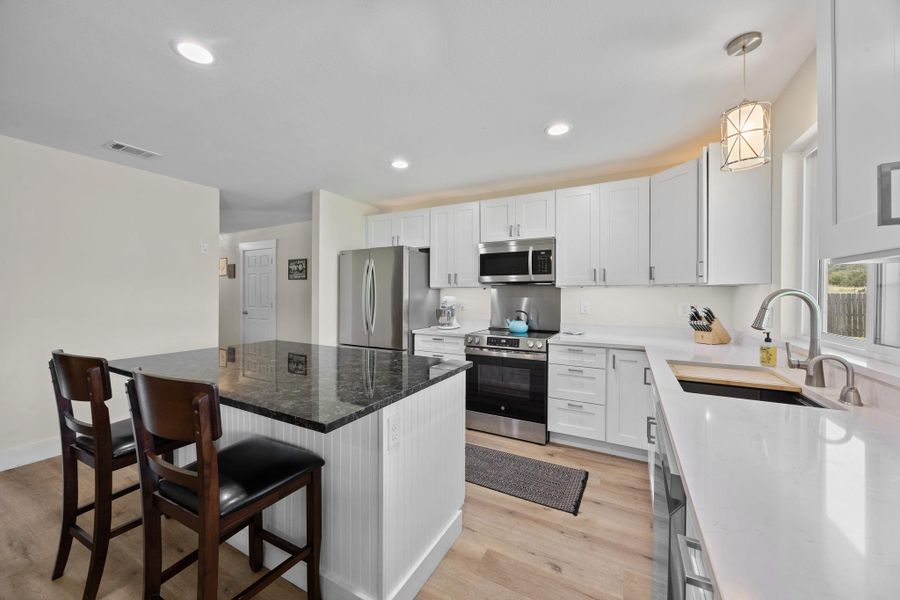Under cabinet lighting and a gorgeous island.
