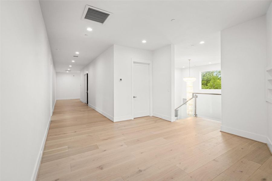 At the top of the stairs, a versatile flex space awaits—ideal as a secondary TV lounge, reading/study area, or whatever best suits your lifestyle. A full-size bathroom nearby features a freestanding soaking tub and a striking polished porcelain accent wall. At the top of the stairs, a versatile flex space awaits—ideal as a secondary TV lounge, reading/study area, or whatever best suits your lifestyle. A full-size bathroom nearby features a freestanding soaking tub and a striking polished porcelain accent wall.