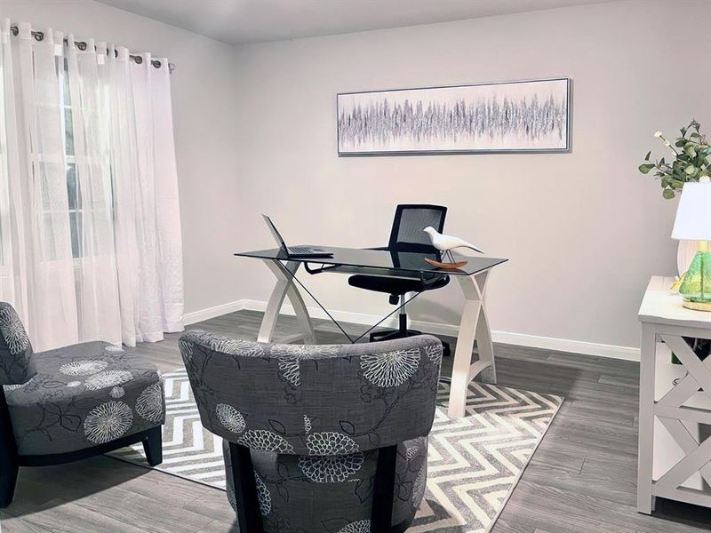 Home office featuring baseboards and wood finished floors